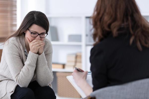 addict woman with ptsd getting help in an addiction treatment center