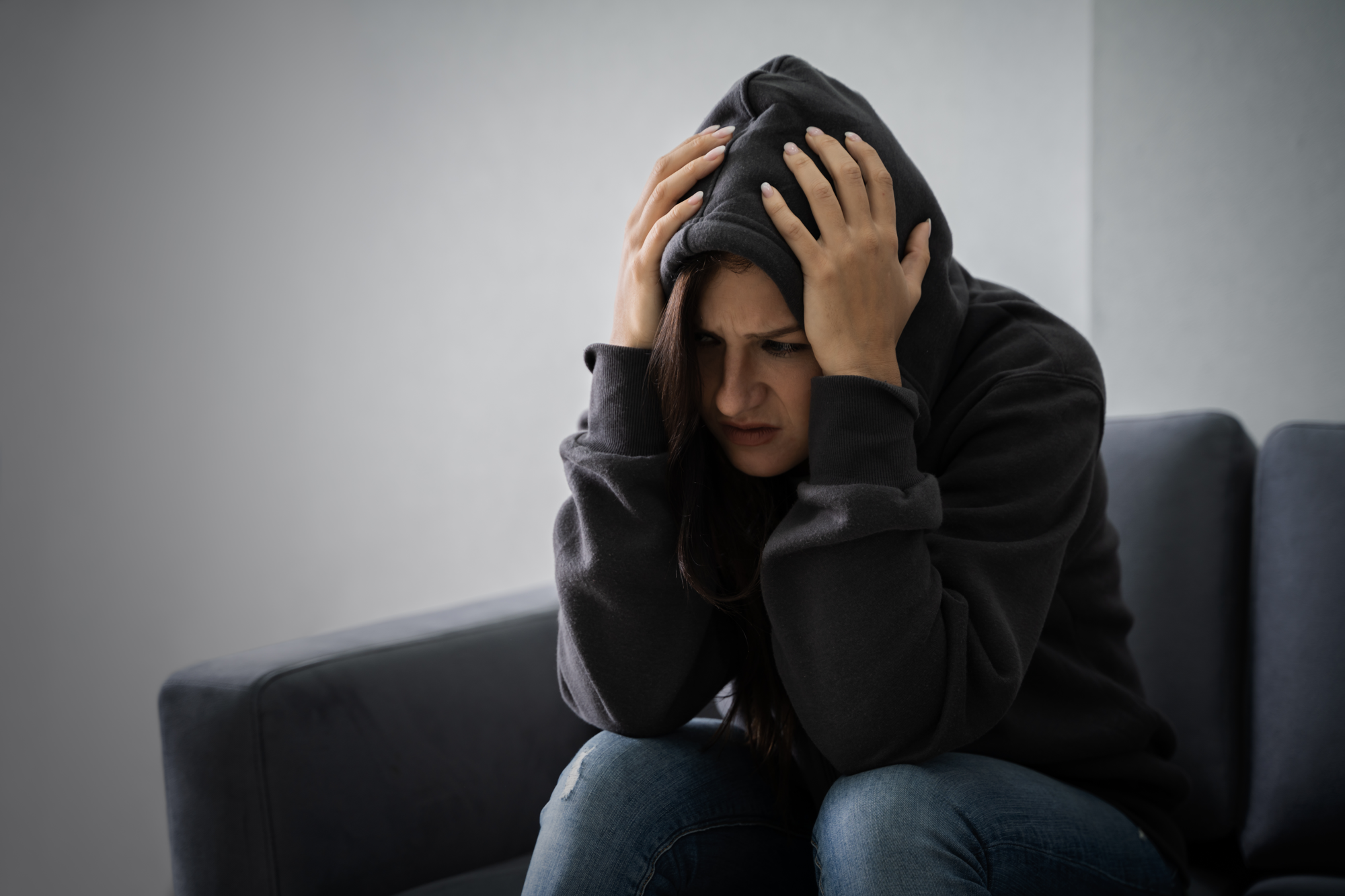 Woman looking distressed while living with PTSD and substance use