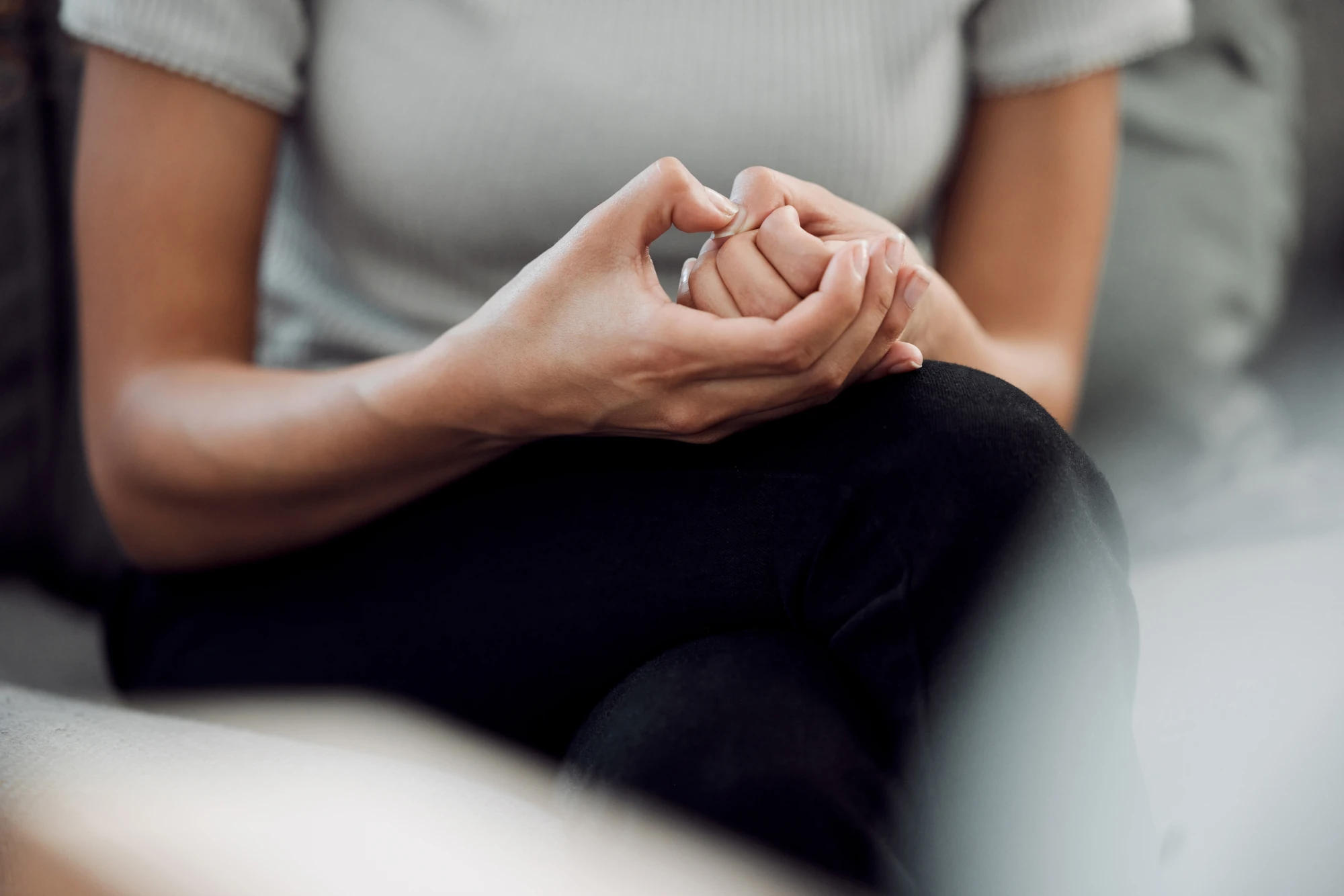 Woman feeling anxious while sitting alone after drinking alcohol.