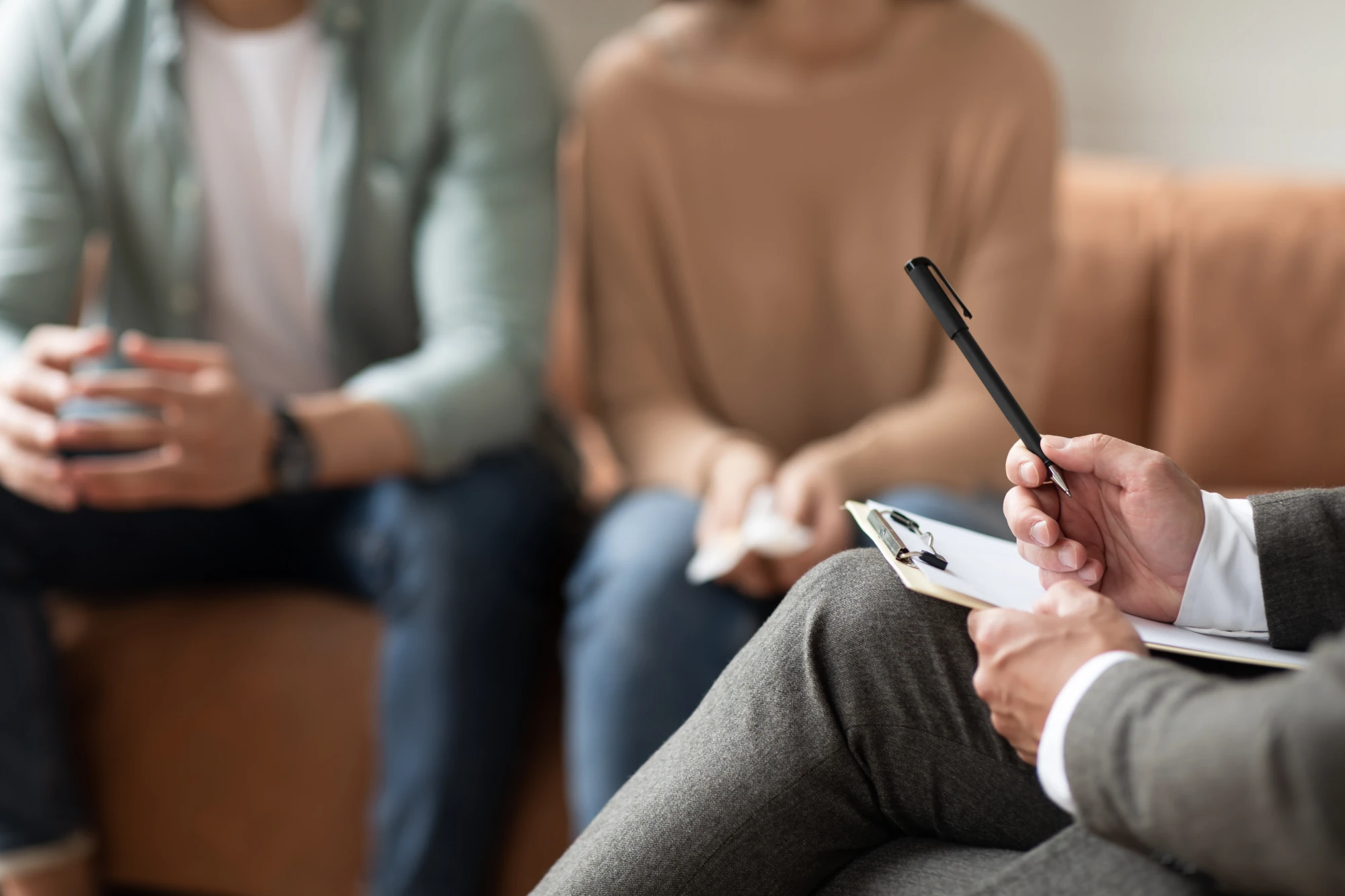 Counselor helping a family understand how to help an alcoholic without enabling.