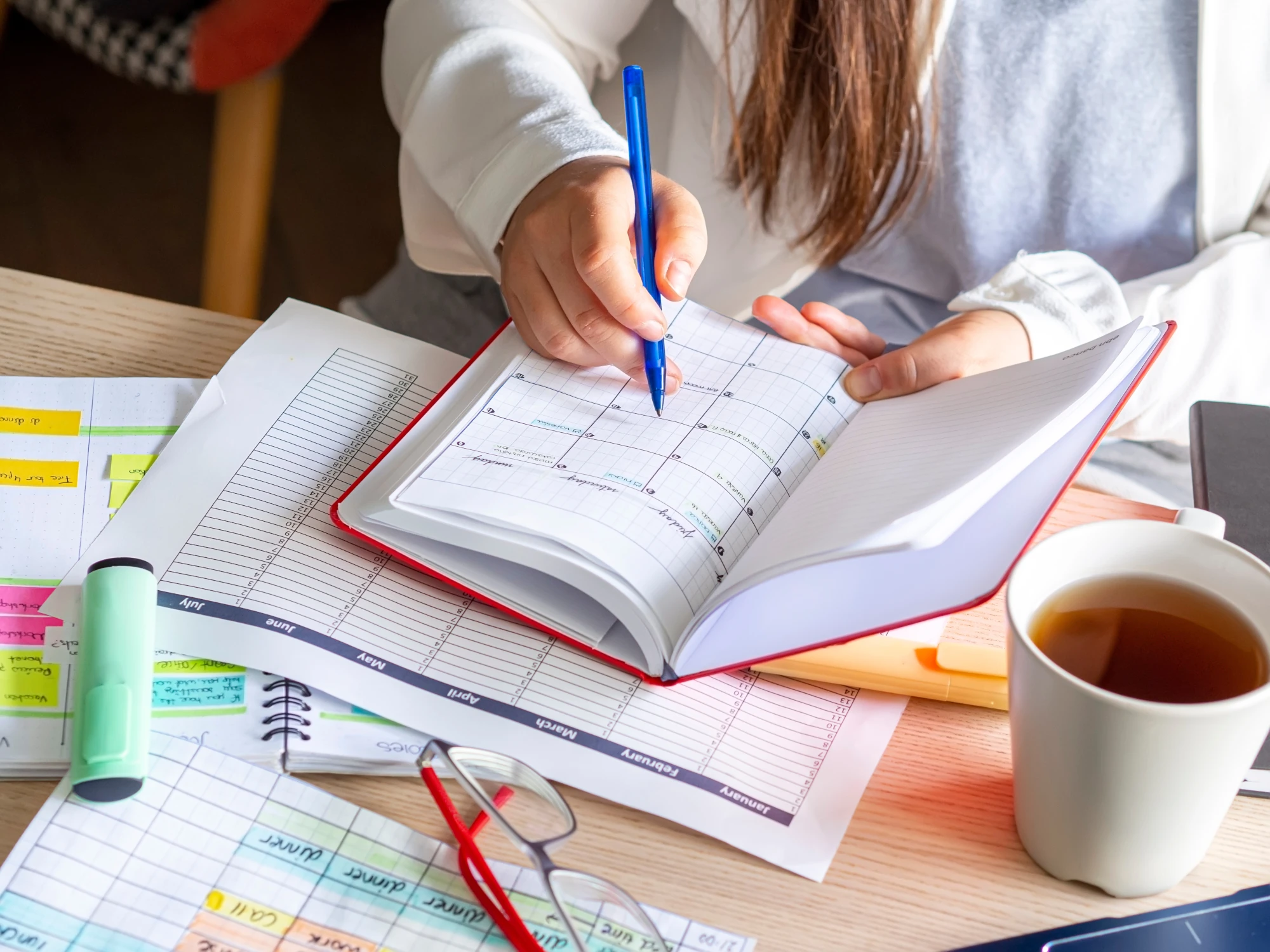 An open monthly calendar planner lying on a desk.