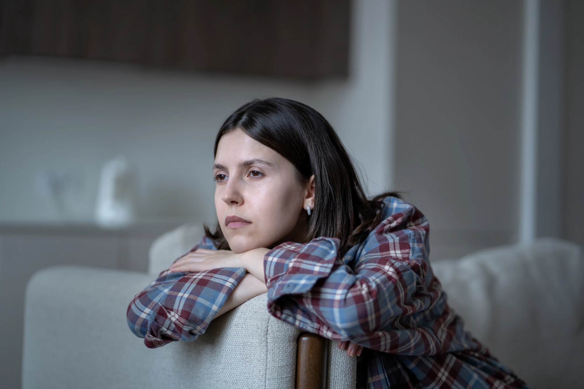 Woman sitting alone while struggling with shame and addiction.