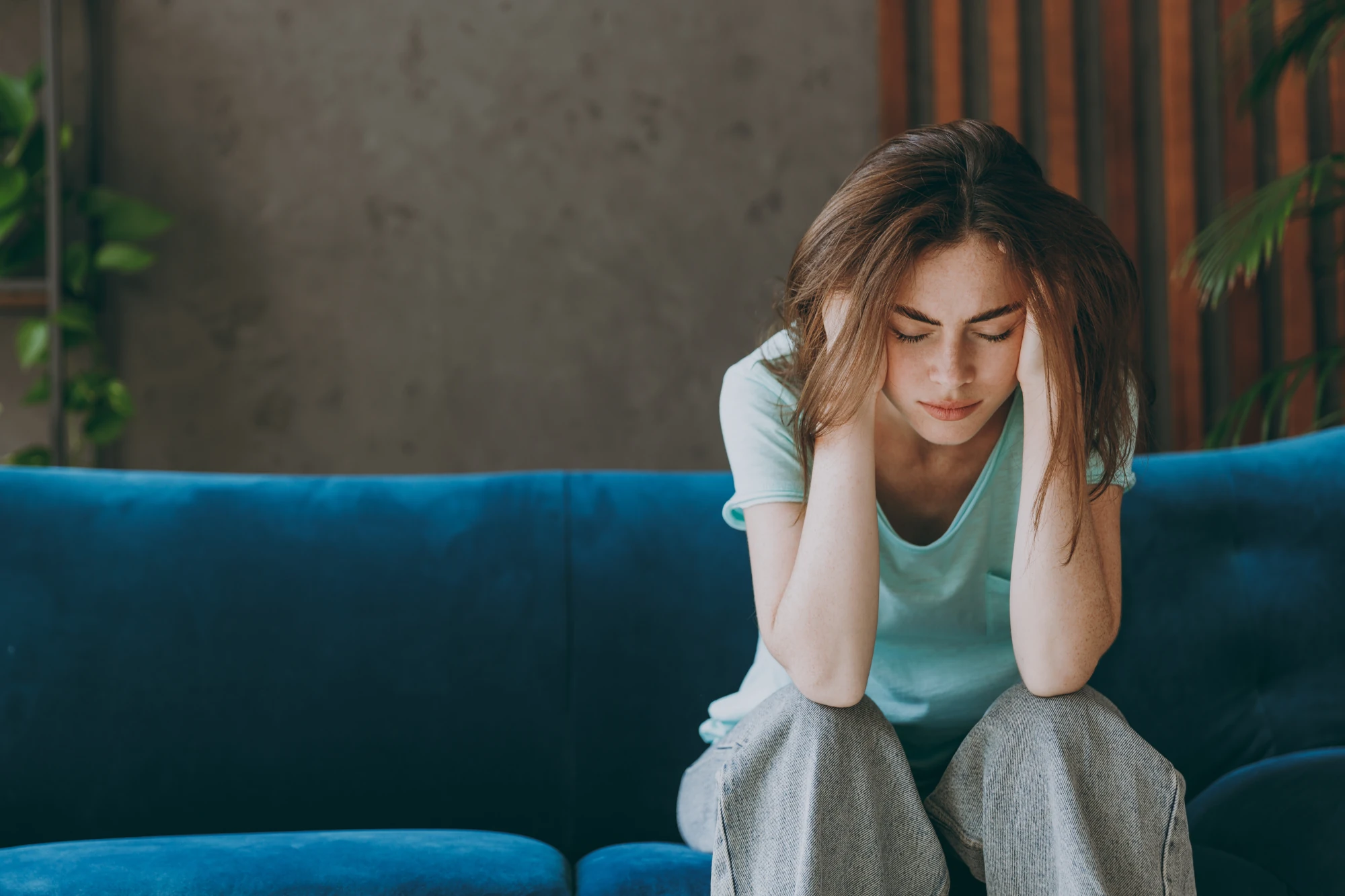 Woman holding her head with a pained expression